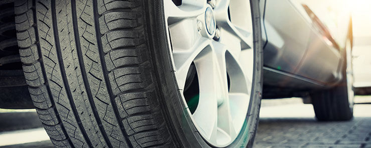 Car tire close up, parked car low angle shot